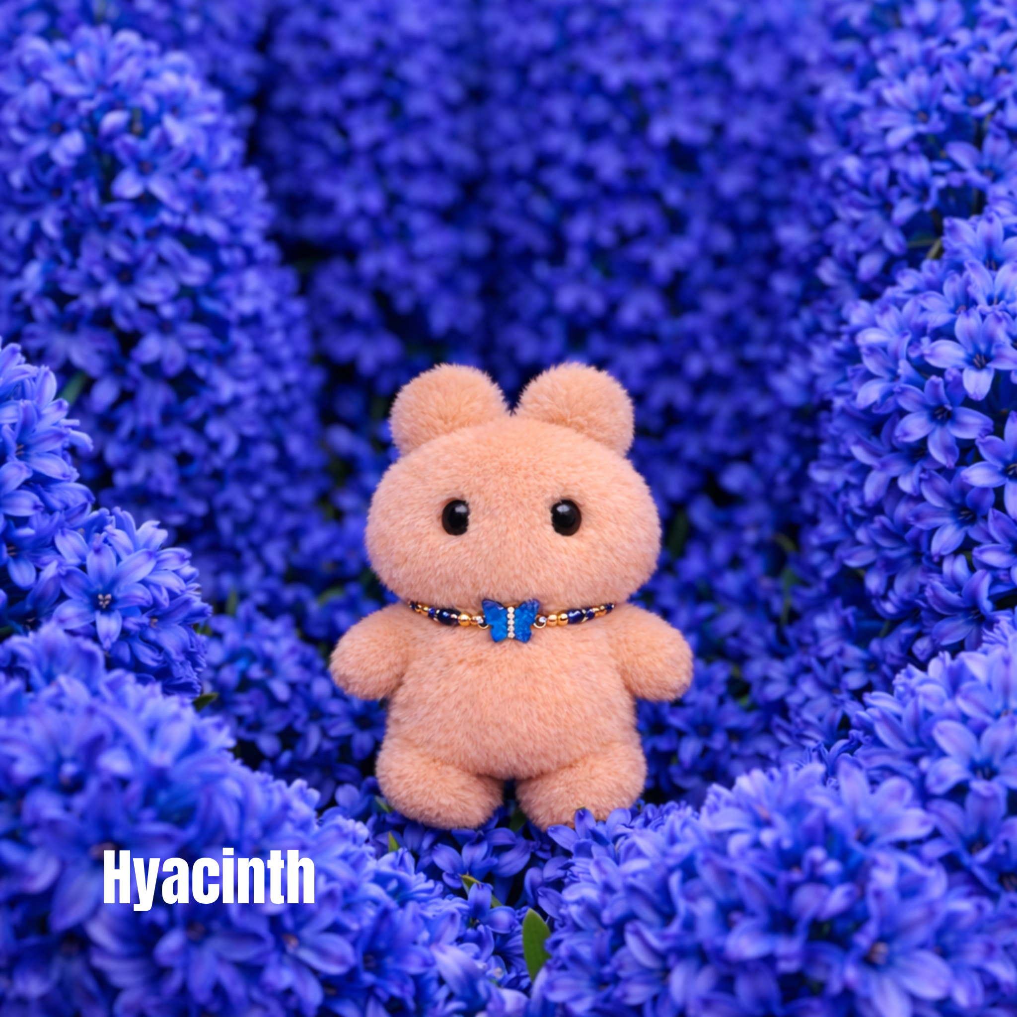 Plush pendant with 'Hyacinth' name tag among royal blue hyacinth flowers