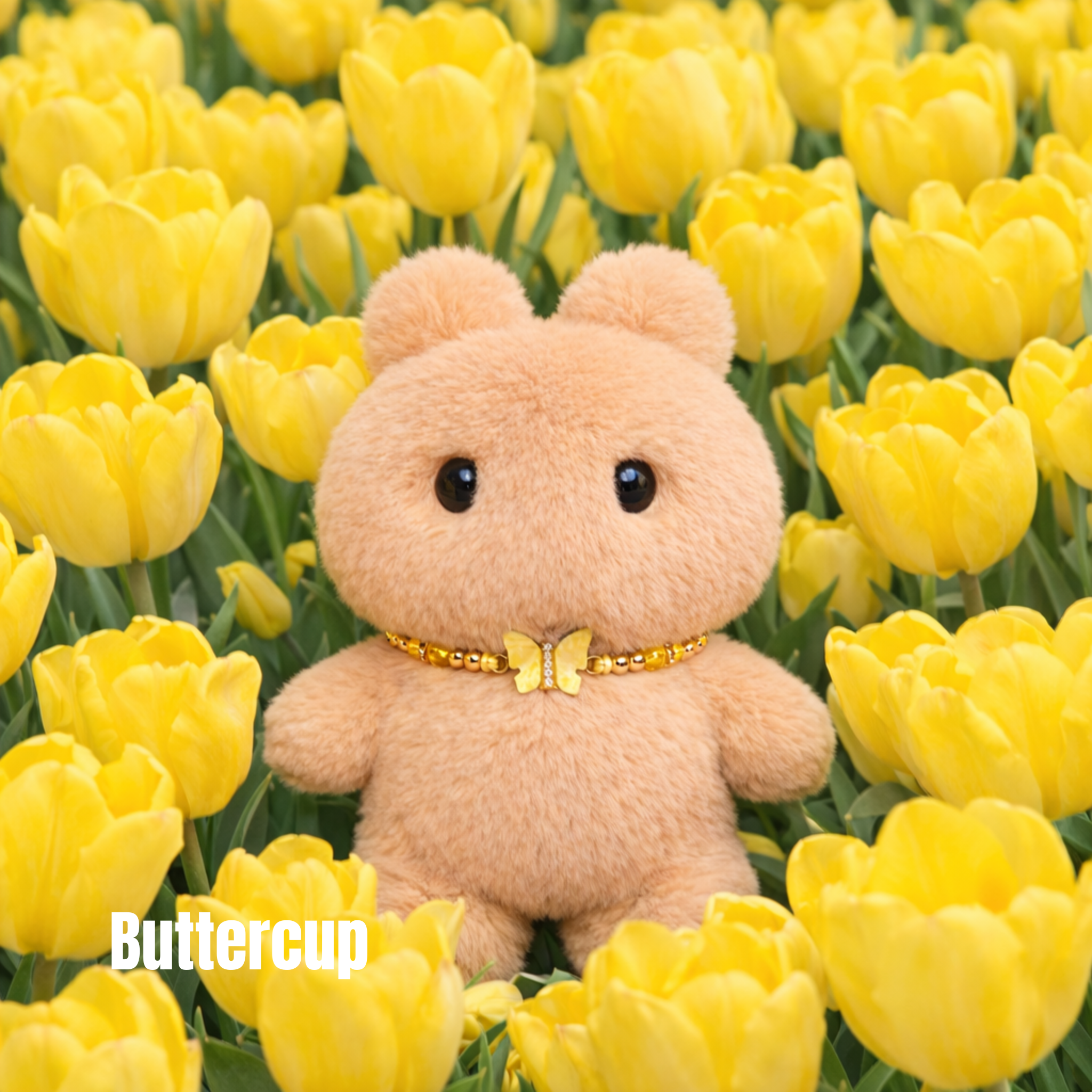 Plush pendant with 'Buttercup' name tag among yellow tullip flowers