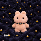 Plush pendant with 'Violet' name tag among black flowers